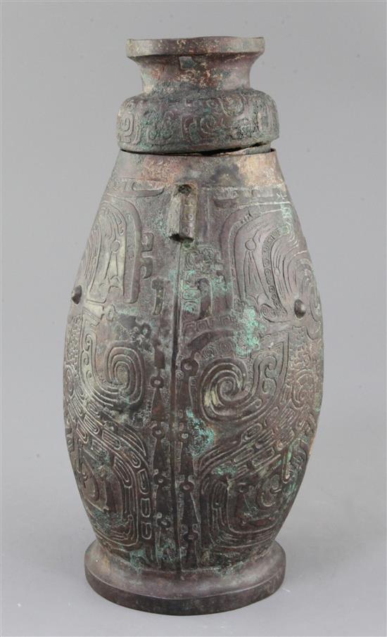 A Chinese archaic bronze ritual drinking vessel and cover, Hu, Western Zhou dynasty, 11th-9th century B.C., 30cm high, faults